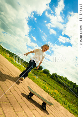 Skater boy child with his skateboard. Outdoor activity. Skater boy child with his skateboard. Outdoor activity. 112183451