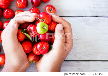 A lot of acerola in hand 112183516