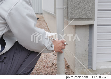 Workers checking rain gutters Workers checking rain gutters 112183673
