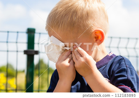 crying unhappy little boy wiping his eyes 112183893