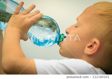 Child drinking pure water from plastic bottle 112184101