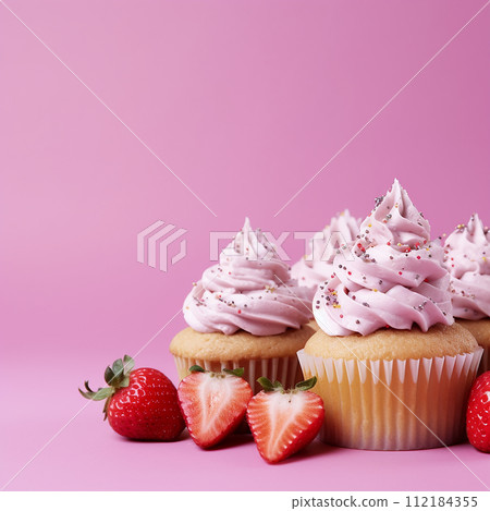 Vanilla cupcake topped with creamy frosting and a fresh strawberry. Vanilla cupcake topped with creamy frosting and a fresh strawberry. 112184355