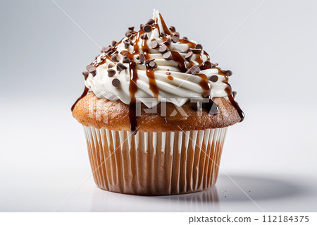 A delectable caramel drizzled cupcake with creamy frosting. 112184375