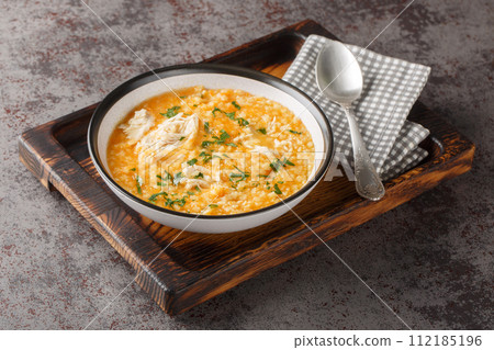 Homemade puree soup with pastina, chicken, vegetables and cheese close-up in a bowl. Horizontal 112185196