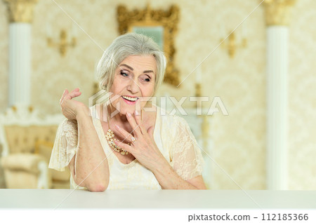 Portrait of beautiful happy senior woman posing 112185366
