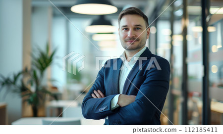 Portrait of a successful  businessman with confident and friendly facial expression and his arms crossed in front of blurred office background. Generative AI 112185411