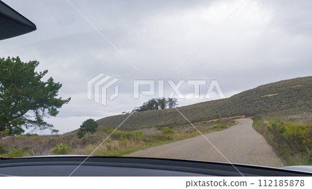In this serene winter scene, a vehicle carefully makes its way along Los Osos Valley Road and Pecho Valley Road within Montana de Oro State Park. In this serene winter scene, a vehicle carefully makes its way along Los Osos Valley Road and Pecho Valley Road within Montana de Oro State Park. 112185878