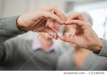 Love heart shape peace. Senior older couple making heart shape with their hands. Adult mature old husband wife showing heart sign. Happy pensioner family. I love you happy valentines day Love heart shape peace. Senior older couple making heart shape with their hands. Adult mature old husband wife showing heart sign. Happy pensioner family. I love you happy valentines day 112186056