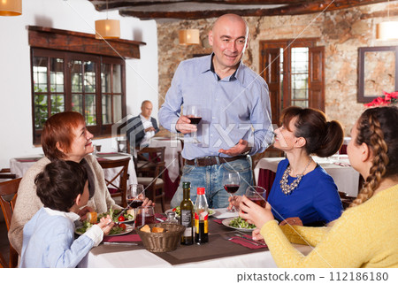 Man saying toast at restaurant 112186180
