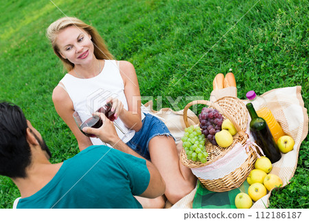 Couple are talking sitting and drinking wine Couple are talking sitting and drinking wine 112186187