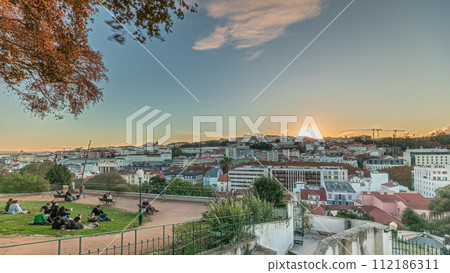 Panorama showing Jardim do Torel timelapse with views to the city center of Lisbon during sunset. Portugal 112186311