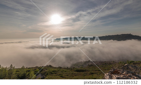 Panorama showing aerial View of Sesimbra Town and Port covered by fog timelapse, Portugal. 112186332