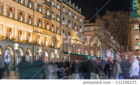 Kaufingerstrasse, shopping street and pedestrian zone in Munich downtown near the Marienplatz night timelapse. Bavaria, Germany 112186375
