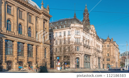 Historical houses on Lenbachplatz square timelapse in Munich, Germany. 112186383