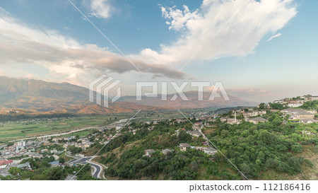 Panorama showing Gjirokastra city from the viewpoint of the fortress of the Ottoman castle of Gjirokaster timelapse. 112186416