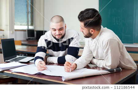 Students preparing for exams in classroom 112186544