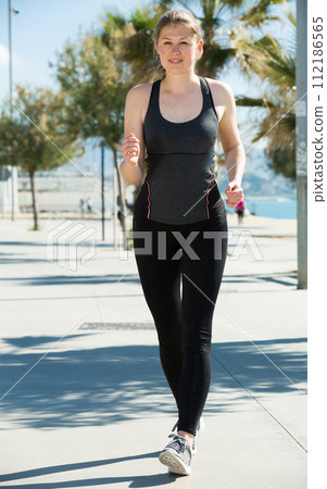 Girl during racewalking training 112186565