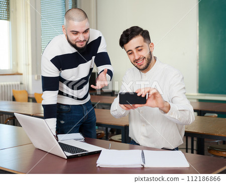 Two students watching at gadget 112186866
