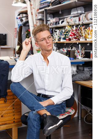 Portrait of young male fashion designer 112186916