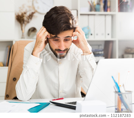 Office worker trying to solve difficult problem Office worker trying to solve difficult problem 112187283