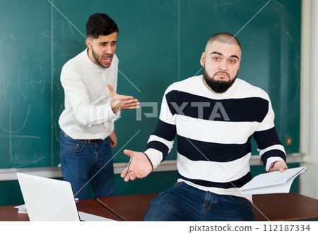 Quarrel between two young male students Quarrel between two young male students 112187334