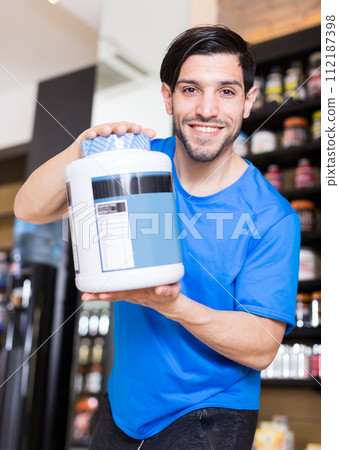 man customer showing sport nutrition products man customer showing sport nutrition products 112187398