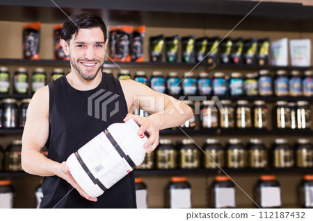 seller showing different sport nutrition 112187432