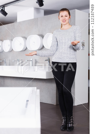 Positive girl customer buying ceramic bath in store Positive girl customer buying ceramic bath in store 112187489