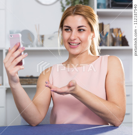 Cheerful girl is taking selfie on phone 112187540