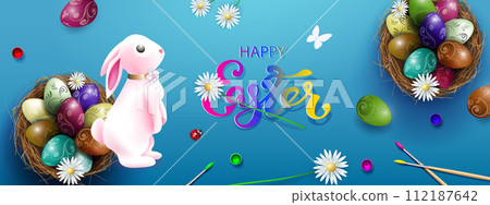 Blue card with Easter eggs in a nest, a beautiful pink bunny Blue card with Easter eggs in a nest, a beautiful pink bunny 112187642