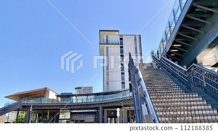 Pedestrian deck and Otoli River side terrace that shines against the clear blue sky in autumn (in front of Meitetsu Higashi-Okazaki Station/Okazaki City, Aichi Prefecture) 112188385