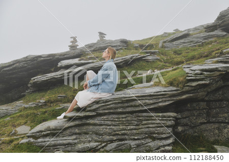A woman hiking in the mountain at summer A woman hiking in the mountain at summer 112188450