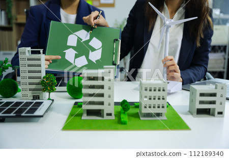 Businessman working virtual modern computer to reduce CO2 emissions carbon footprint climate change to limit global warming.Sustainable development and innovation green business concept. 112189340