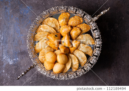 Delectable pastries arranged beautifully on a silver platter. Delectable pastries arranged beautifully on a silver platter. 112189494