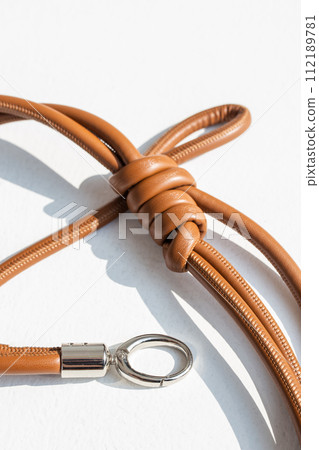 Genuine leather bag strap or handbag handle in brown color isolated on white background 112189781