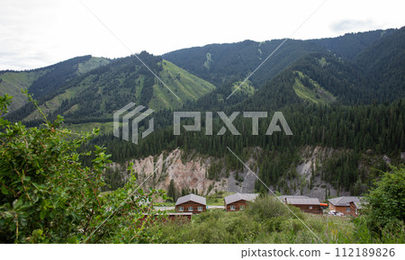 protected areas of Kazakhstan in a picturesque mountain yurt camp on the river bank 112189826