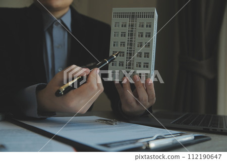 Real estate agent and customer signing contract to buy house, insurance or loan real estate.rent a house,get insurance or loan real estate or property. Real estate agent and customer signing contract to buy house, insurance or loan real estate.rent a house,get insurance or loan real estate or property. 112190647