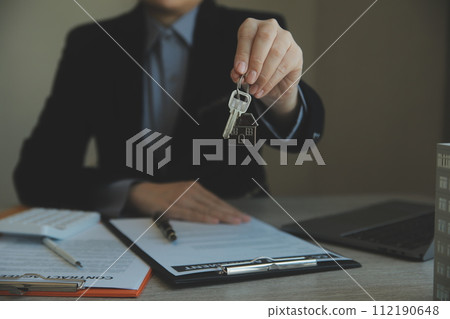 Real estate agent and customer signing contract to buy house, insurance or loan real estate.rent a house,get insurance or loan real estate or property. 112190648