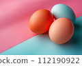 Three Eggs on Blue and Pink Surface 112190922
