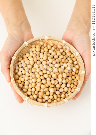 Woman's hand holding soybeans 112191115