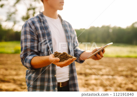 Gardening or ecology concept. Farmer's hands collects soil and checks its health before growing crop 112191840
