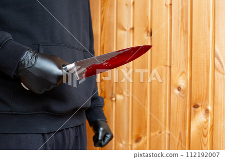 Killer in black gloves with bloody knife Killer in black gloves with bloody knife 112192007