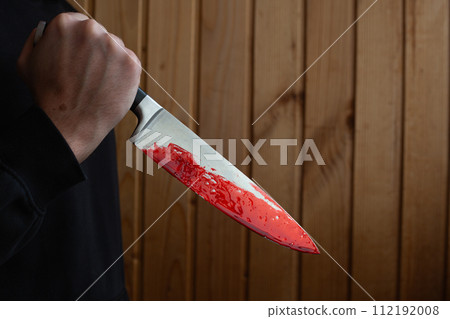 Bloody knife in hand with reverse grip 112192008