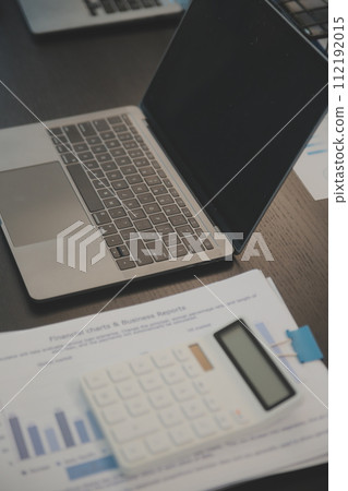 Laptop on a desk in an open financial office. 112192015