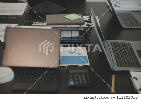 Laptop on a desk in an open financial office. 112192016