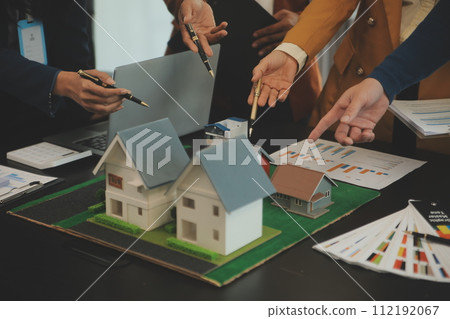 Team of architectures and businessmen discussing and brainstorming on floor plan modification for real estate investment and housing development project 112192067