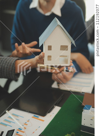 Team of architectures and businessmen discussing and brainstorming on floor plan modification for real estate investment and housing development project 112192077