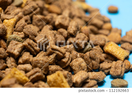 Dry food for kittens and cats close-up. A complete cat diet Dry food for kittens and cats close-up. A complete cat diet 112192663