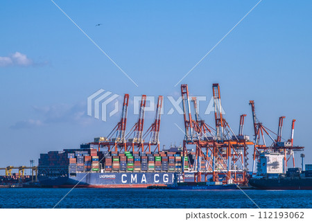 Yokohama cityscape in Japan Container ship CMA CGM PRIDE at Honmoku Pier. On the far right is ENGAGE = March 3rd 112193062