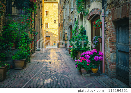 Cozy narrow street decorated with flowers and green plants, Italy Cozy narrow street decorated with flowers and green plants, Italy 112194261